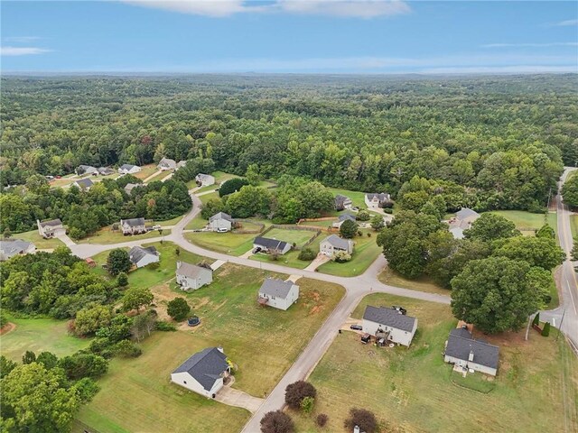 birds eye view of property with a wooded view