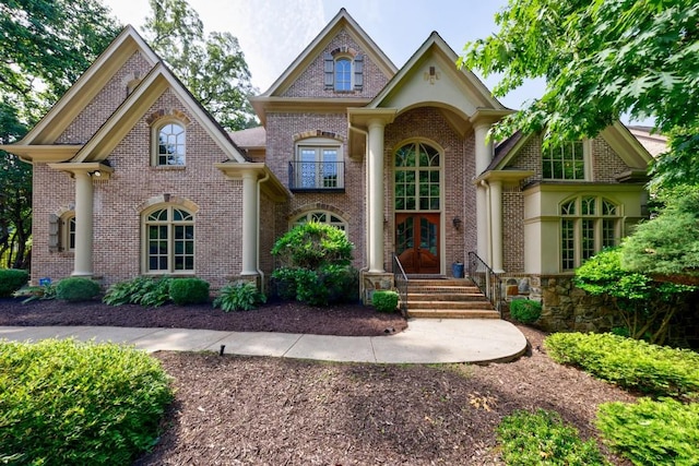 view of front facade with french doors and brick siding