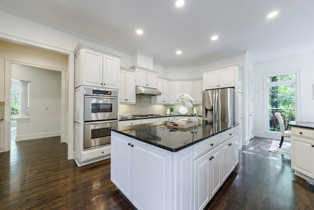 kitchen featuring stainless steel appliances, white cabinets, and under cabinet range hood