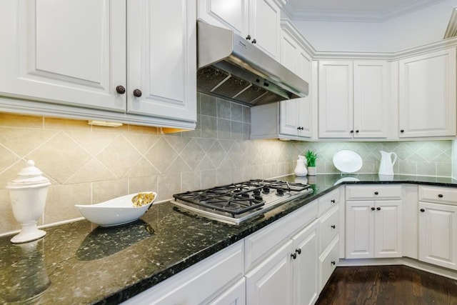 kitchen with decorative backsplash, crown molding, under cabinet range hood, stainless steel gas stovetop, and white cabinetry