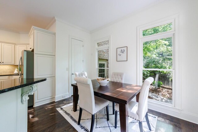 dining room with ornamental molding, dark wood-style flooring, and baseboards