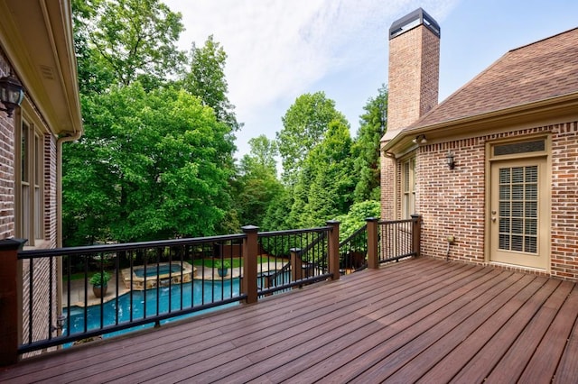 wooden terrace featuring an in ground hot tub and an outdoor pool