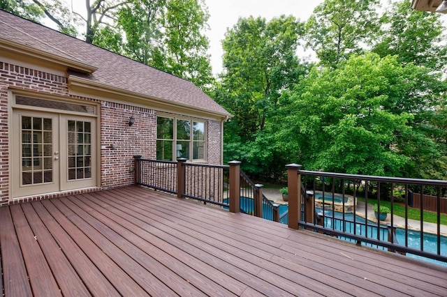 deck with french doors and an outdoor pool