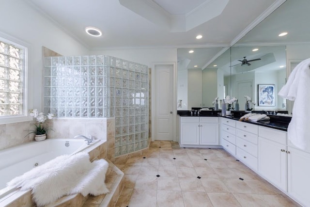 bathroom featuring ceiling fan, a tub with jets, ornamental molding, vanity, and recessed lighting