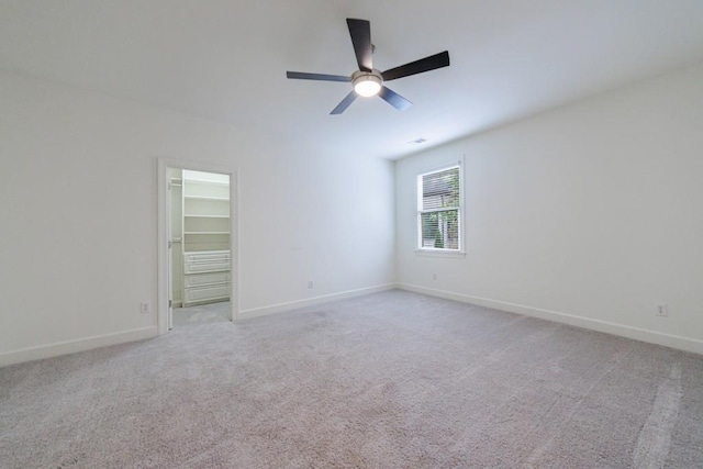 unfurnished room featuring baseboards, a ceiling fan, and light colored carpet