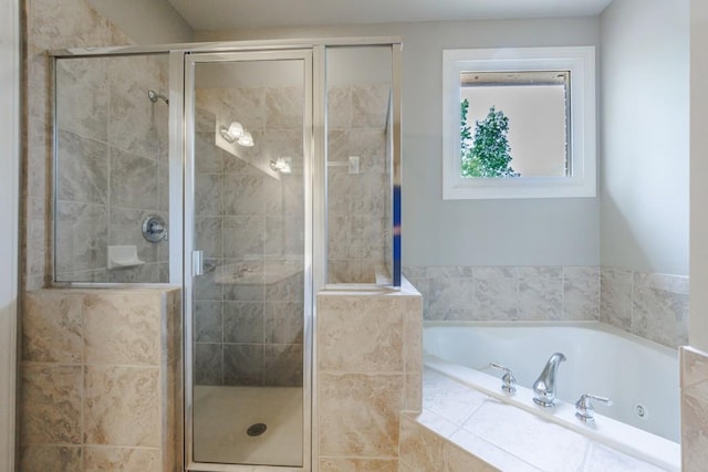 bathroom with a shower stall and a bath