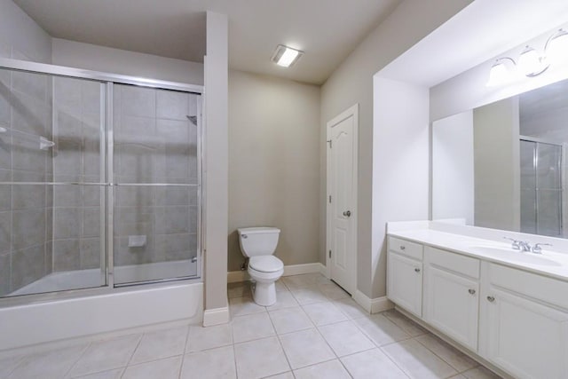 full bathroom featuring baseboards, toilet, tile patterned flooring, combined bath / shower with glass door, and vanity