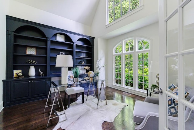 office area with high vaulted ceiling and wood finished floors