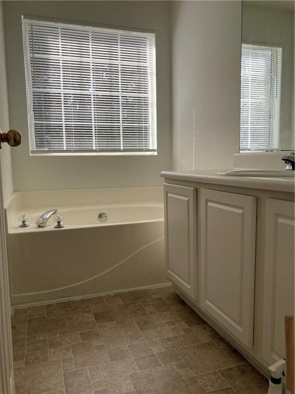 bathroom with a bathtub and vanity