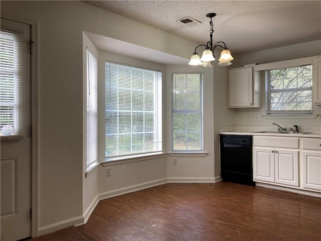 kitchen with pendant lighting, black dishwasher, and a wealth of natural light