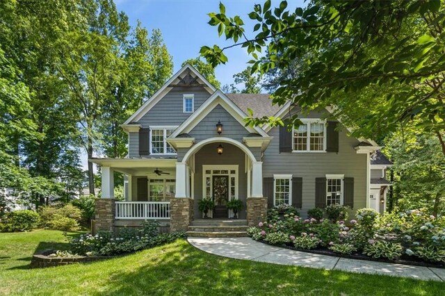 view of front facade with a front yard and covered porch