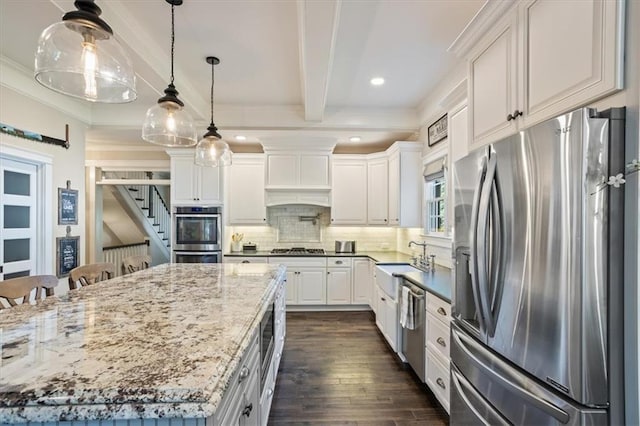 kitchen featuring appliances with stainless steel finishes, beamed ceiling, tasteful backsplash, white cabinets, and hanging light fixtures