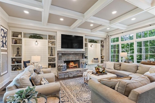 living room featuring a stone fireplace, built in features, wood-type flooring, coffered ceiling, and beam ceiling