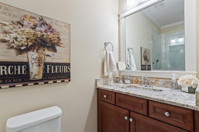 bathroom with crown molding, vanity, and toilet