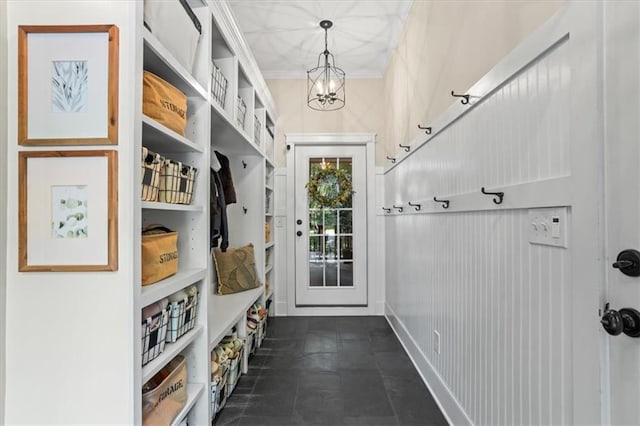 mudroom featuring ornamental molding and a chandelier