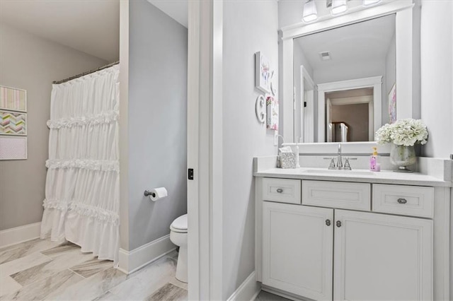 bathroom featuring vanity and toilet