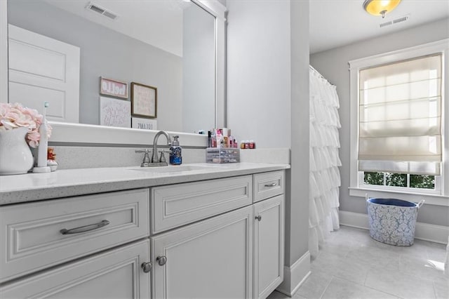 bathroom with tile patterned flooring and vanity