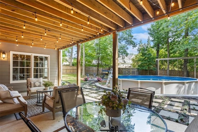 view of patio featuring outdoor lounge area and a fenced in pool