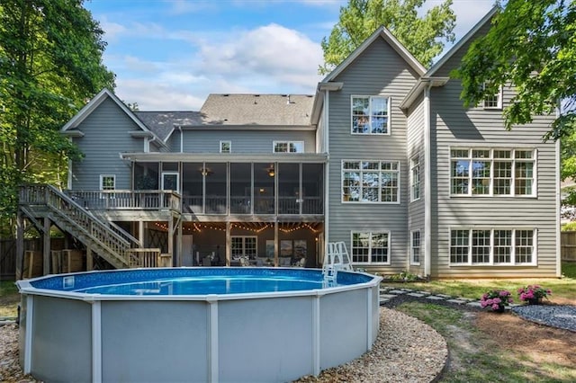 rear view of house with a sunroom and a swimming pool side deck