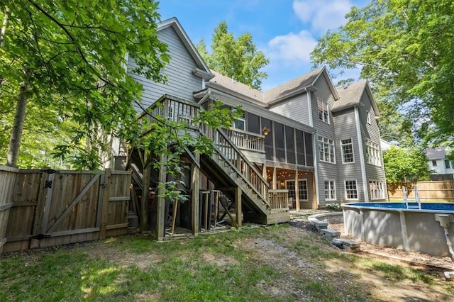 back of house featuring a swimming pool side deck and a sunroom