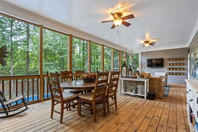 sunroom / solarium with ceiling fan and a healthy amount of sunlight