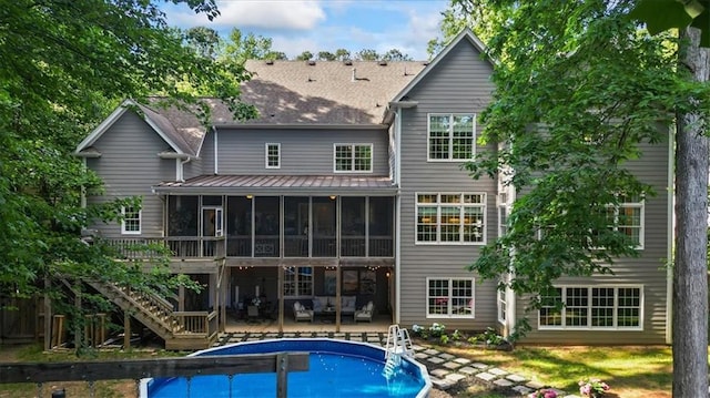 back of house with a patio area and a sunroom