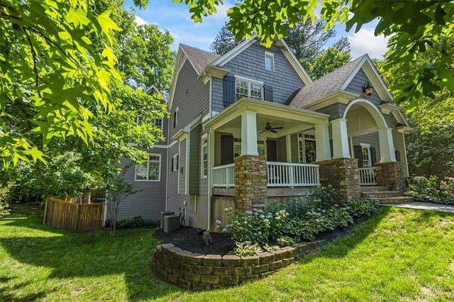 exterior space featuring a porch, cooling unit, ceiling fan, and a lawn