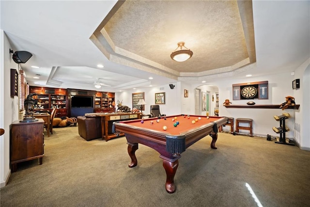 playroom with a raised ceiling, carpet flooring, and a textured ceiling