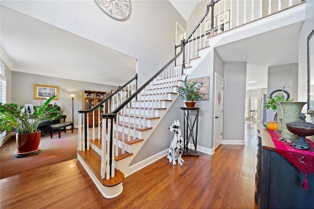 staircase with hardwood / wood-style floors