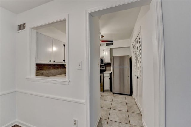 kitchen with white cabinetry, ceiling fan, light tile patterned flooring, and appliances with stainless steel finishes