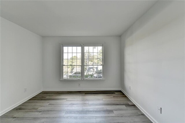 spare room with light hardwood / wood-style floors