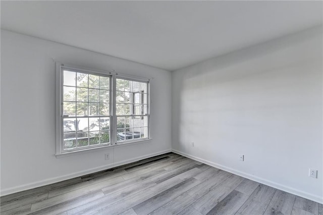 unfurnished room with light hardwood / wood-style flooring