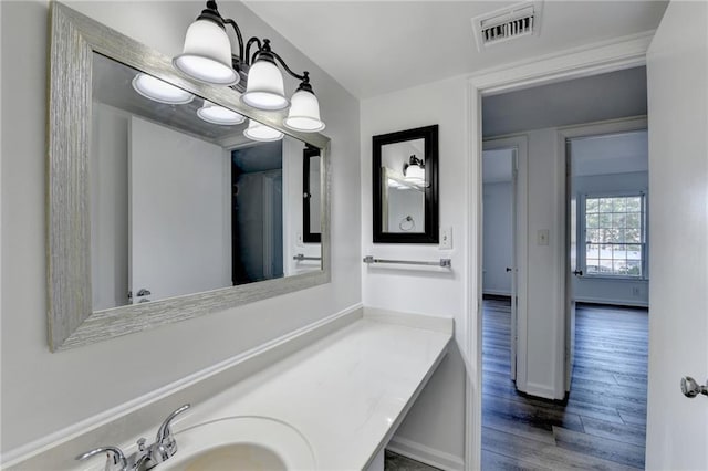 bathroom with hardwood / wood-style floors and vanity