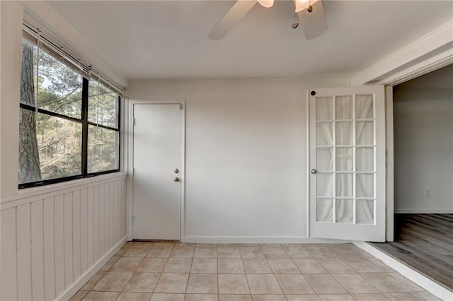 unfurnished room with ceiling fan and light tile patterned flooring