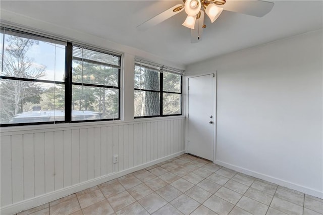 spare room featuring ceiling fan and light tile patterned floors