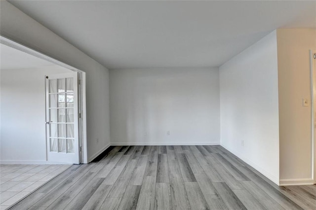 empty room with light hardwood / wood-style flooring