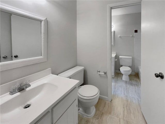 bathroom with toilet and vanity