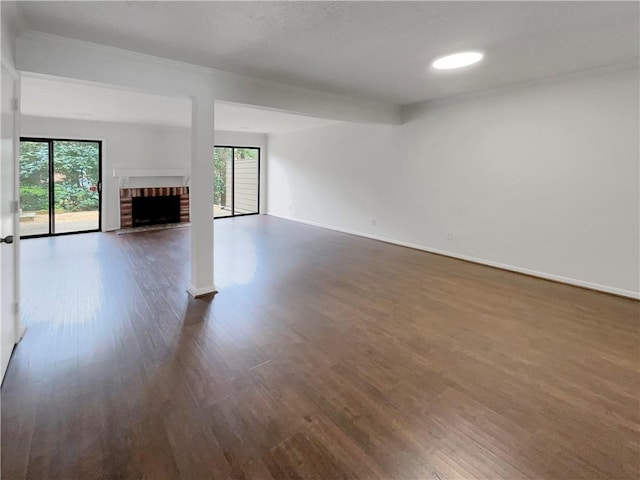 unfurnished living room with dark hardwood / wood-style floors and a fireplace