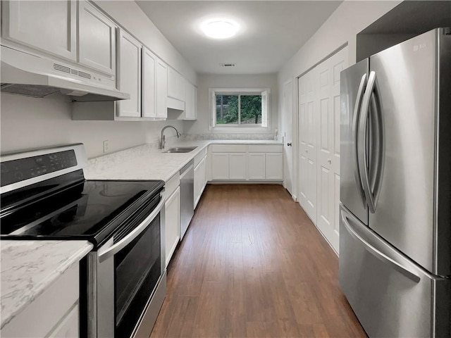 kitchen featuring sink, white cabinetry, light stone countertops, dark hardwood / wood-style floors, and appliances with stainless steel finishes