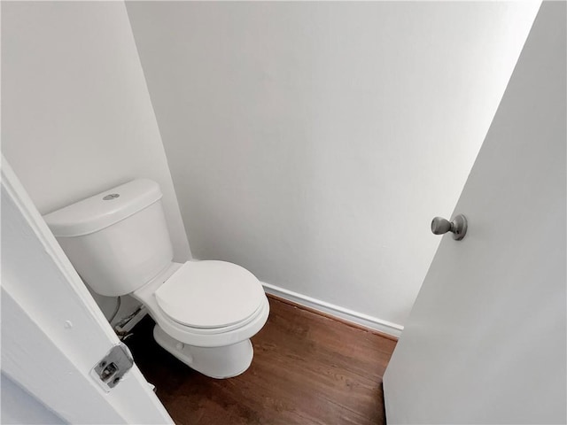 bathroom with toilet and wood-type flooring