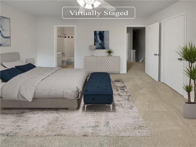 carpeted bedroom featuring ensuite bath