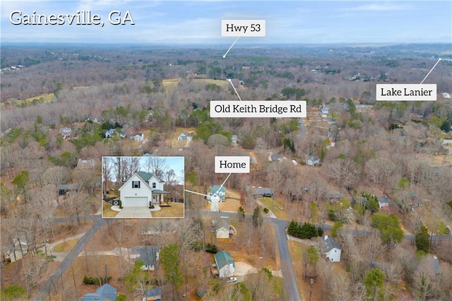 bird's eye view with a wooded view