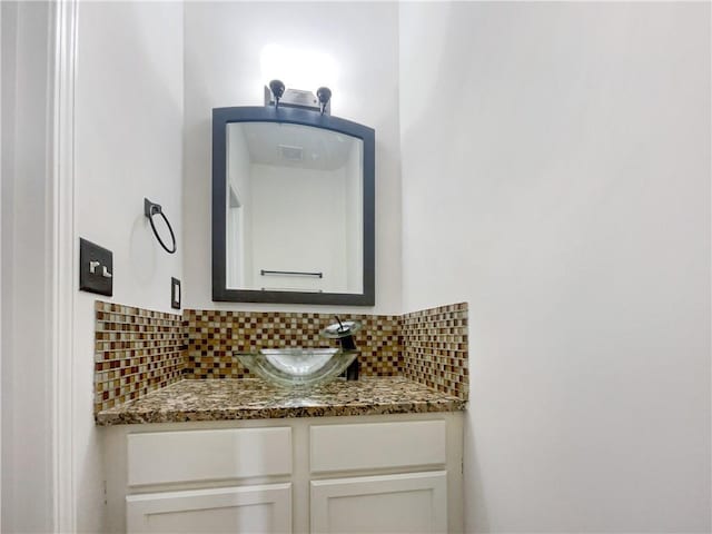 bathroom with vanity and backsplash