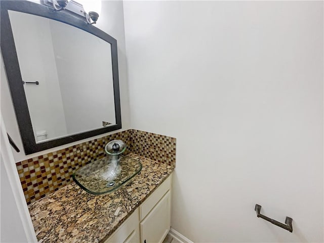 bathroom featuring tasteful backsplash, vanity, and toilet