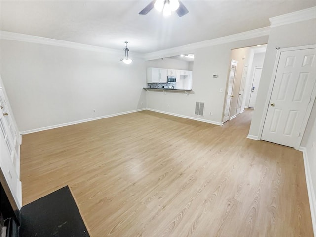 unfurnished living room featuring ornamental molding, ceiling fan, and light hardwood / wood-style flooring