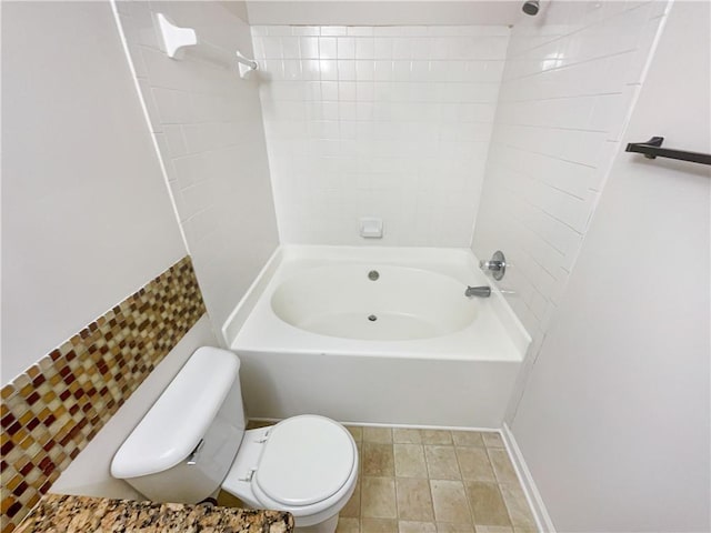 bathroom featuring washtub / shower combination and toilet