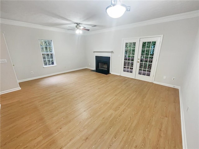 unfurnished living room with ceiling fan, ornamental molding, and light wood-type flooring