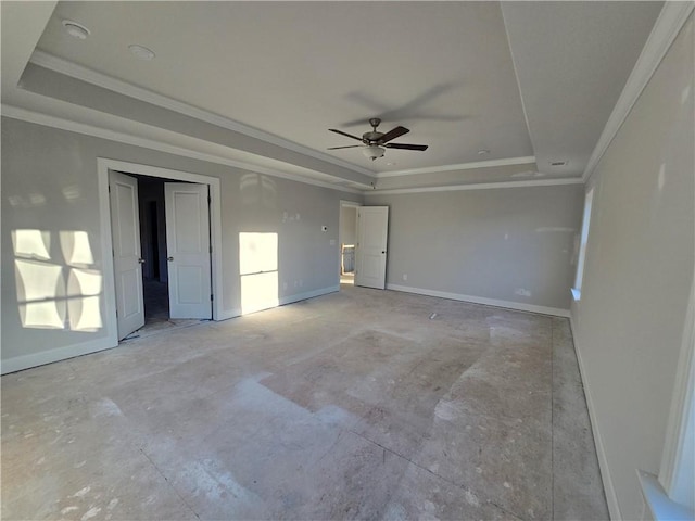 unfurnished room featuring a raised ceiling, crown molding, and ceiling fan