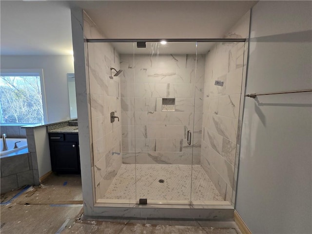 bathroom featuring vanity and independent shower and bath