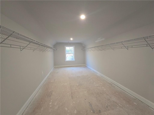 walk in closet with vaulted ceiling